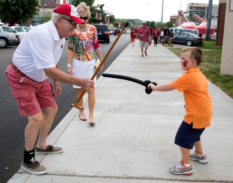 Jackson Braun, 6, of Bowling Green Kentucky has a sword fight with his grandfather before the WKU vs. Bowling Green football game on August 29th, 2014.